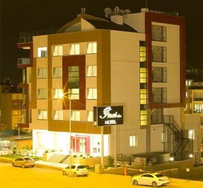 A multi-story hotel with a prominent sign reading "Fais Hotel."