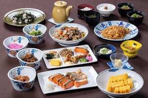A variety of dishes and bowls on a table, suggesting a meal setting.