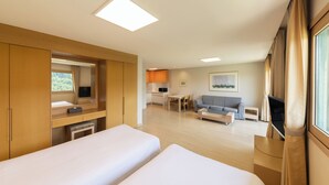 A modern hotel room with two beds, a kitchenette, a dining area, and a TV. - Oak Valley Valley Village (Wonju)