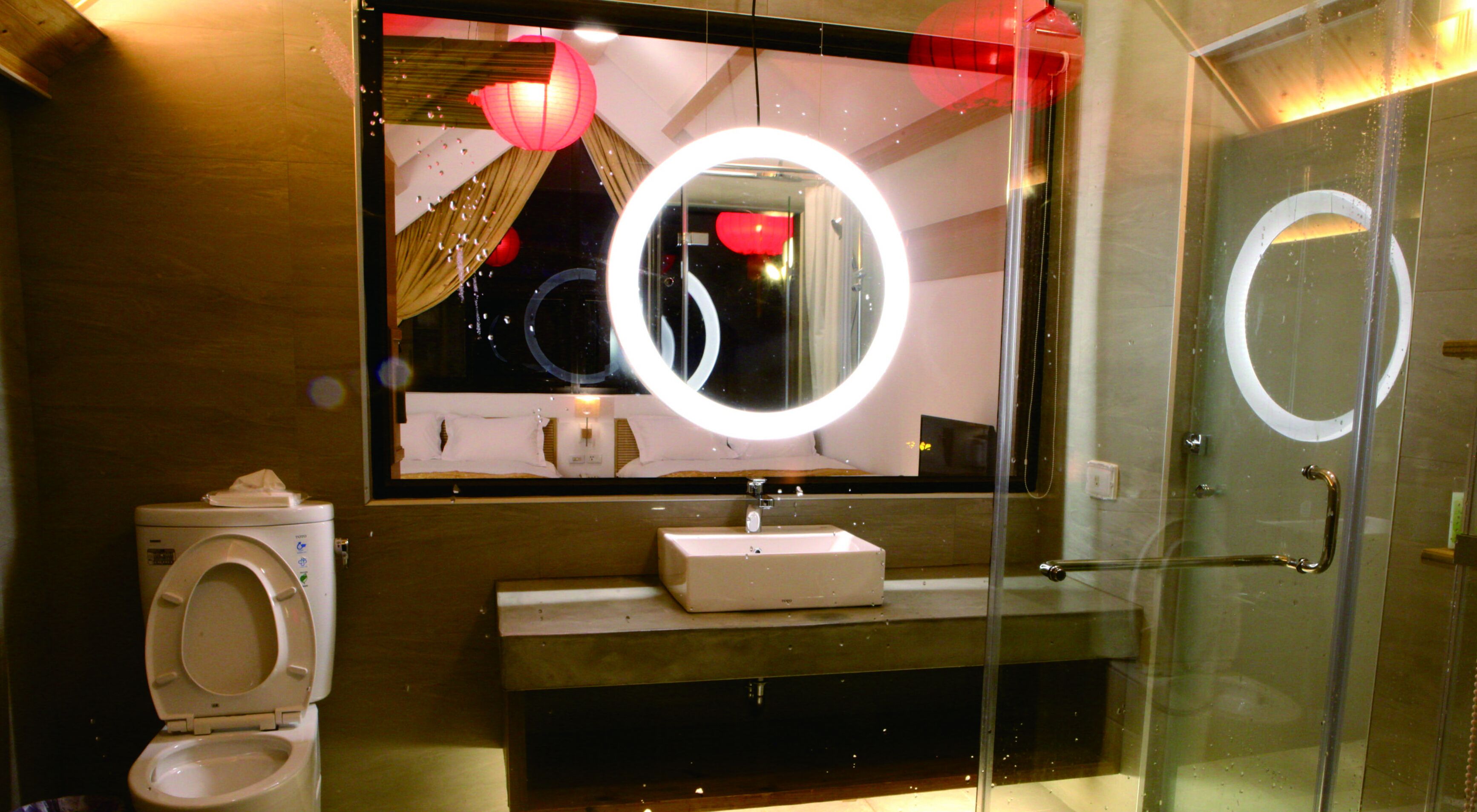 Ein modernes Badezimmer mit Toilette, Waschbecken und Spiegel.