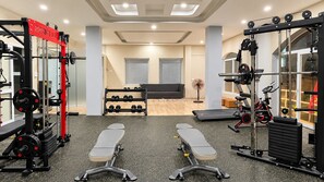 A home gym with exercise equipment, a bench, and a fan. -  A25 Premium Hotel - 29 Thác Bạc Sapa (Sa Pa)