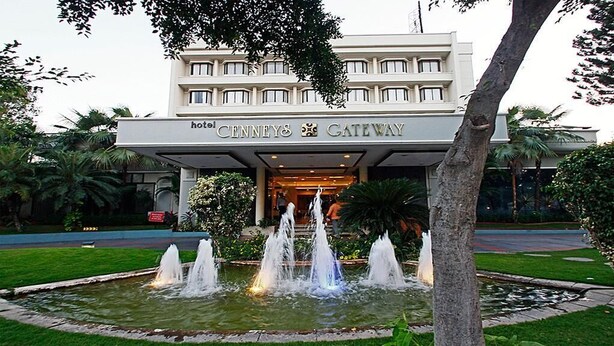 The entrance of the Hotel Cecil's Gateway with a fountain and lush greenery. - Cenneys Gateway - Pride of Salem (Salem)