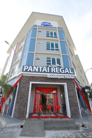 A multi-story boutique hotel named PANTAI REGAL with a prominent entrance, stone facade, and red decorative elements. - Pantai Regal Hotel (Kuantan)