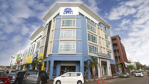 A hotel with a blue and white facade, multiple windows, and a sign indicating it is a hotel. - Pantai Regal Hotel (Kuantan)