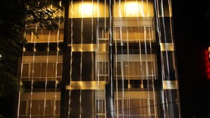 A multi-story building with a prominent illuminated sign reading "CANYON SUN." - Canyonsun (Chennai)