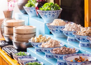 A buffet table with various dishes in blue and white patterned bowls, including dumplings, vegetables, and meat. - C&D Hotel Fuzhou (Fuzhou)