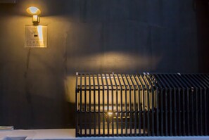 A wall-mounted sign with text and a light fixture. - Group STAY CLASSE 01 (Osaka)