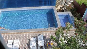 Indoor pool, outdoor pool, open 8 AM to 11 PM, pool loungers