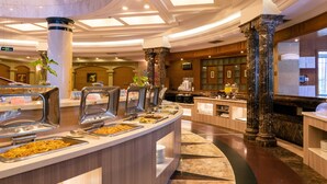 A buffet area with multiple serving stations, marble flooring, and classical architectural columns. - Marine Garden Hotel (Xiamen)