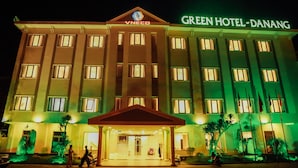 A multi-story hotel with a prominent entrance and signage for "GREEN HOTEL-DANANG". - Green Hotel Danang (Da Nang)