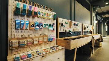 A wax bar with various wax melts and tools displayed on pegboards.