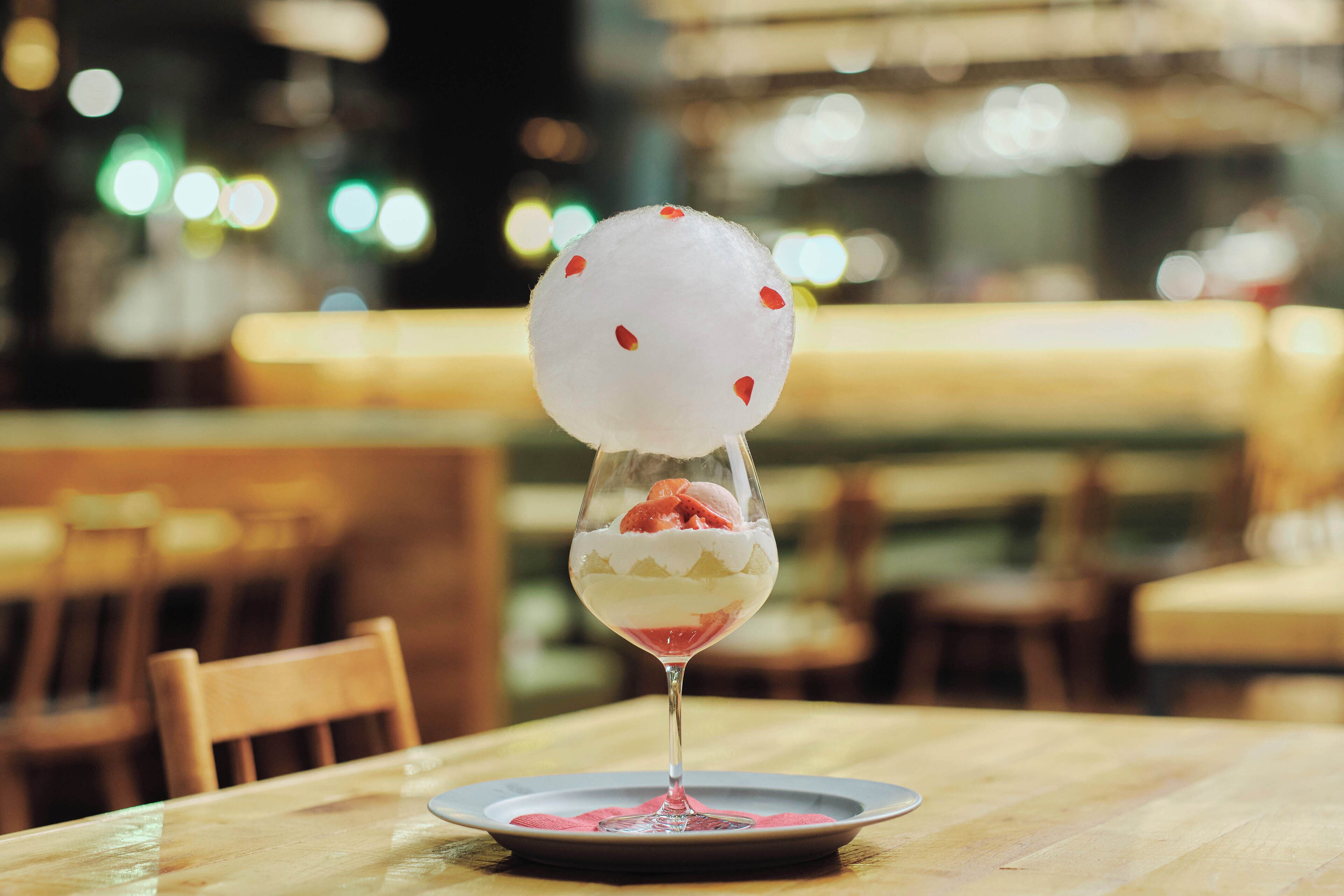 A dessert in a glass on a table in a restaurant.