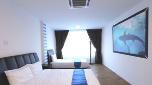 A hotel room with a large bed, a smaller bed, a window with curtains, a wall-mounted air conditioner, and a framed picture of a shark. - Hard Rock VIP Guest House (Mersing)