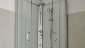 A modern bathroom with a glass-enclosed shower, a white sink, and a toilet. - Bizzi LuxHeart of Old Town Apartment (Warsaw)