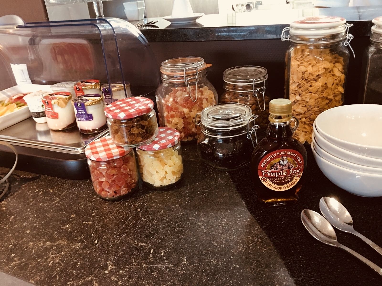 A breakfast buffet with various food items and condiments.