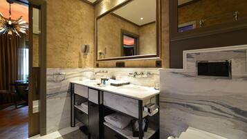 A bathroom with a double sink, a large mirror, and a marble countertop.