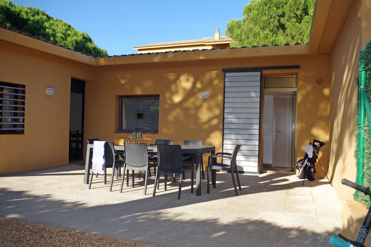 A patio with a table and chairs, a door, and a window.