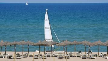 On the beach, sun loungers, beach umbrellas, beach towels