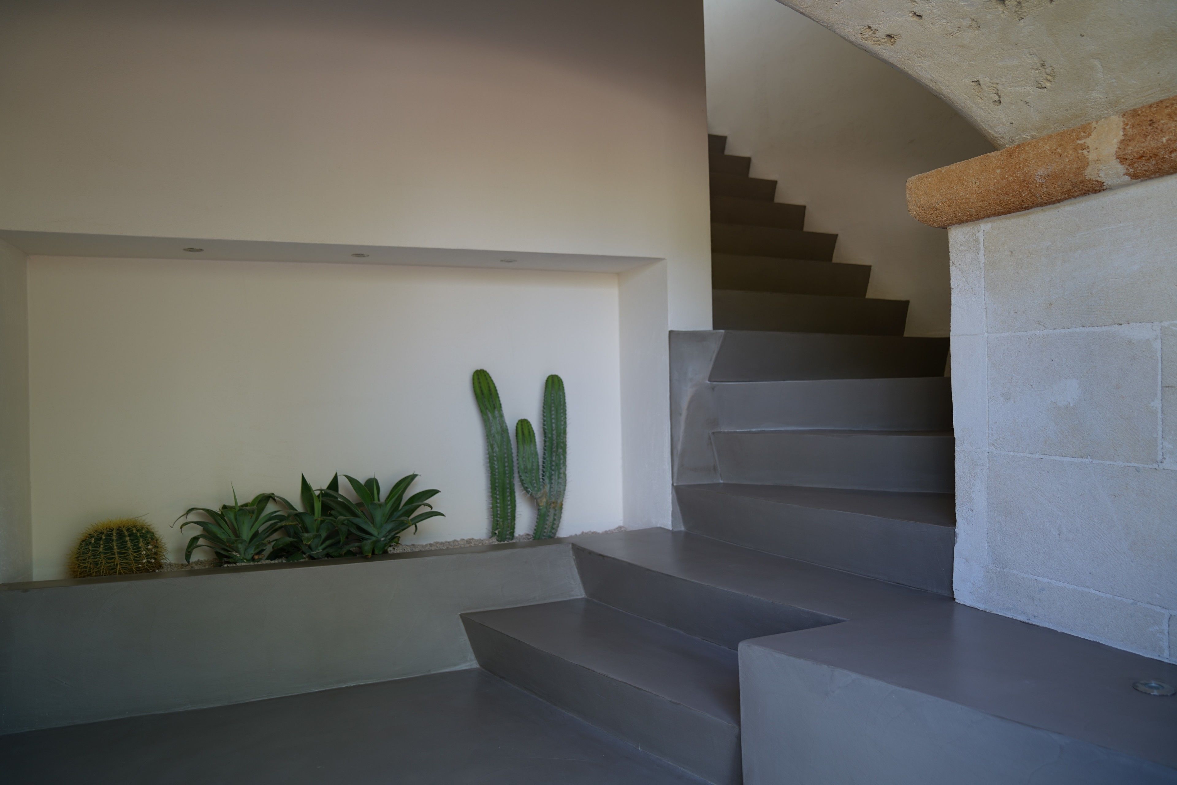 A staircase with a modern design, leading to an upper floor.