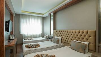 Standard Triple Room | Minibar, in-room safe, desk, soundproofing