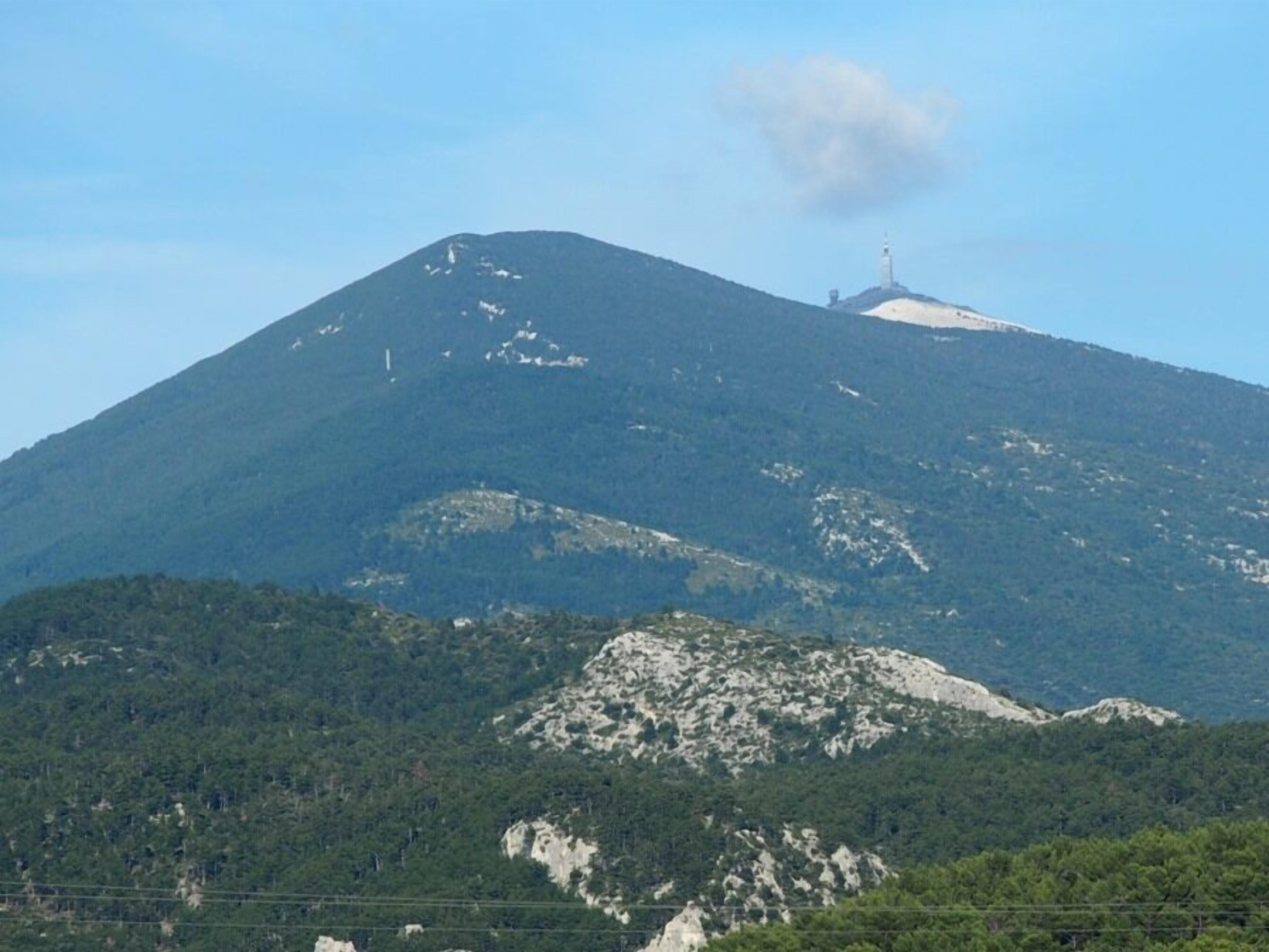 A mountain with a radio tower on top.