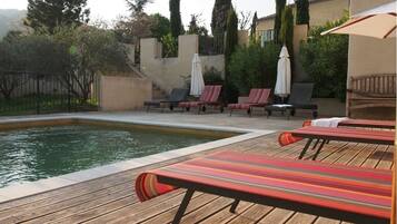 Outdoor pool, a heated pool, open 9:00 AM to 8:00 PM, pool umbrellas