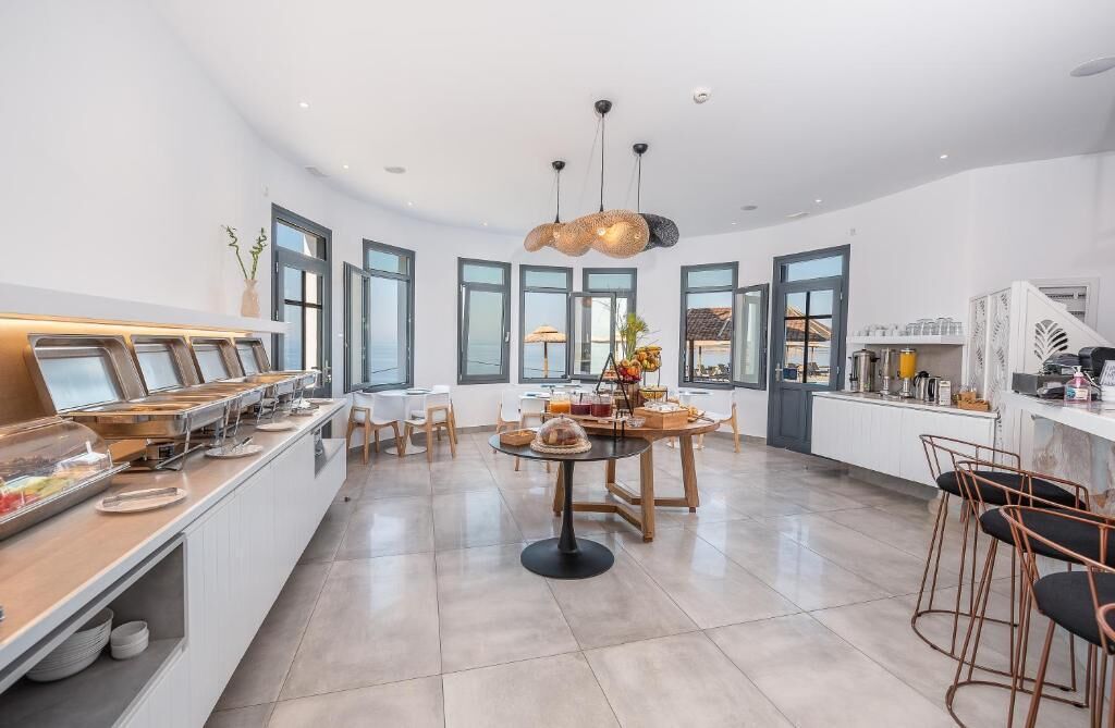 A modern kitchen with a buffet, large windows, and a central island.