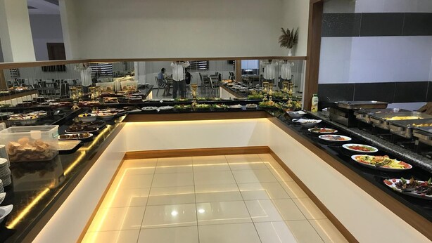 A buffet setup with various food items and a tiled floor. - Grand Ari Hotel (Afyonkarahisar)