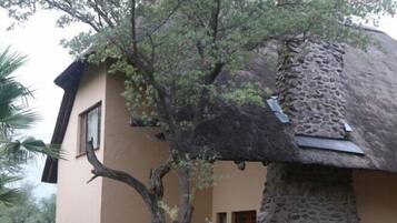 A building with a stone exterior and a thatched roof.