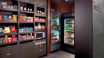 A well-stocked snack and beverage refrigerator with various brands and types of food and drinks.