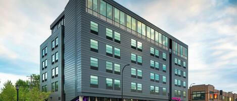 Un edificio moderno de varios pisos con ventanas amplias y techo plano.