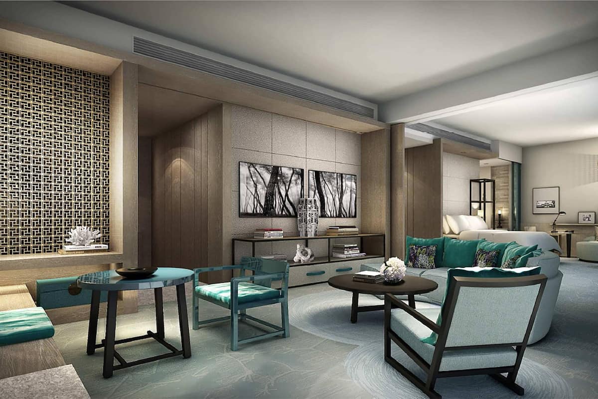 A modern living room with a sofa, two armchairs, a coffee table, and a decorative wall with abstract art.