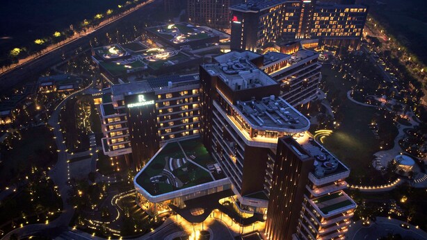 A high-rise hotel complex with multiple buildings, interconnected walkways, and landscaped areas. - Renaissance Suzhou Taihu Lake Hotel (Suzhou)