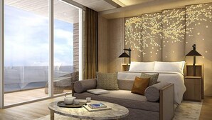 A modern hotel room with a large sliding glass door, a sofa, a bedside table with a book, and a wall with a decorative light fixture. - Renaissance Suzhou Taihu Lake Hotel (Suzhou)