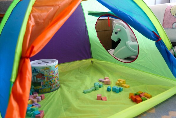 A colorful tent with a toy horse inside, filled with various building blocks. - Le Meridien Xi'an Chanba (Xi'an)