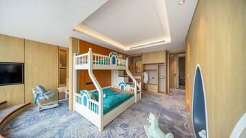 Een stapelbed met een televisie, een bureau en een stoel in een kamer met houten wanden en een kamerbreed tapijt met dessin.