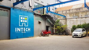 A hostel with a blue exterior and a staircase leading to an upper level. - Intech Hostel (Bandung)