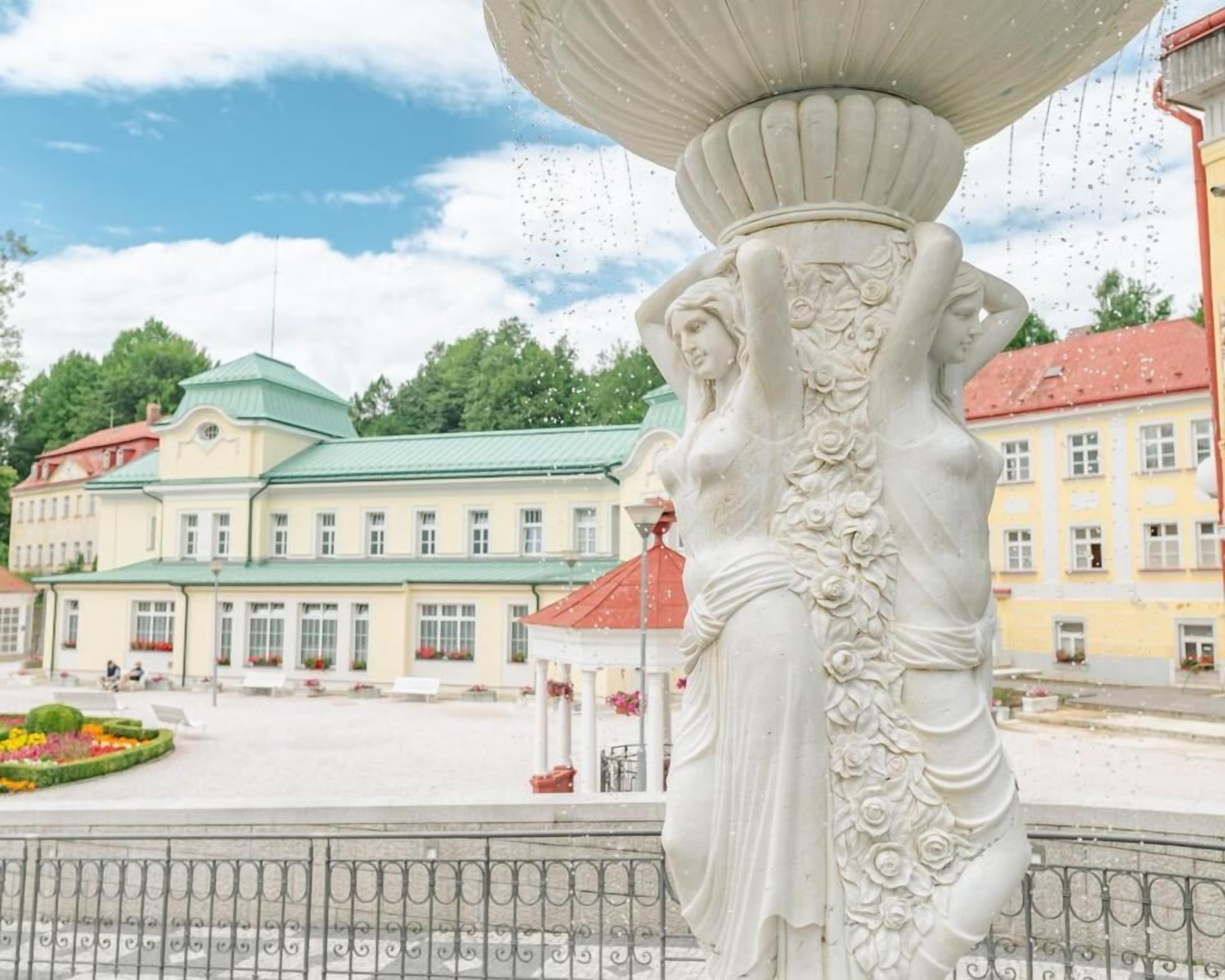 A classical statue with intricate carvings in a public square.