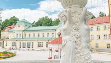 A classical statue with intricate carvings in a public square.