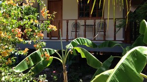 A house with a porch, a wooden door, and a window. - Areeya Resort (Sa Kaeo)