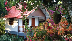 A house with a red roof, white walls, and a wooden balcony. - Areeya Resort (Sa Kaeo)