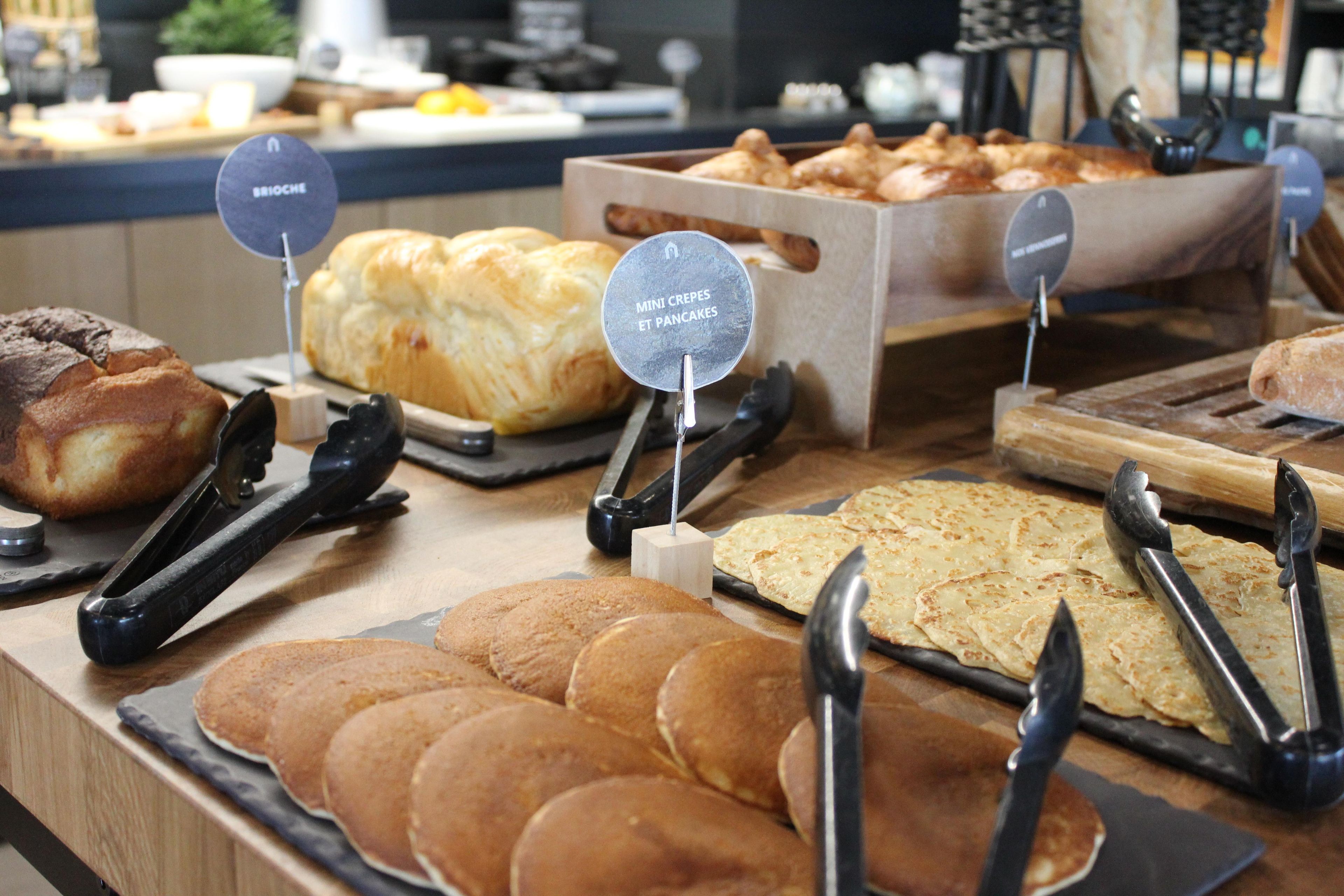 A variety of baked goods displayed on a counter with labels indicating different types.