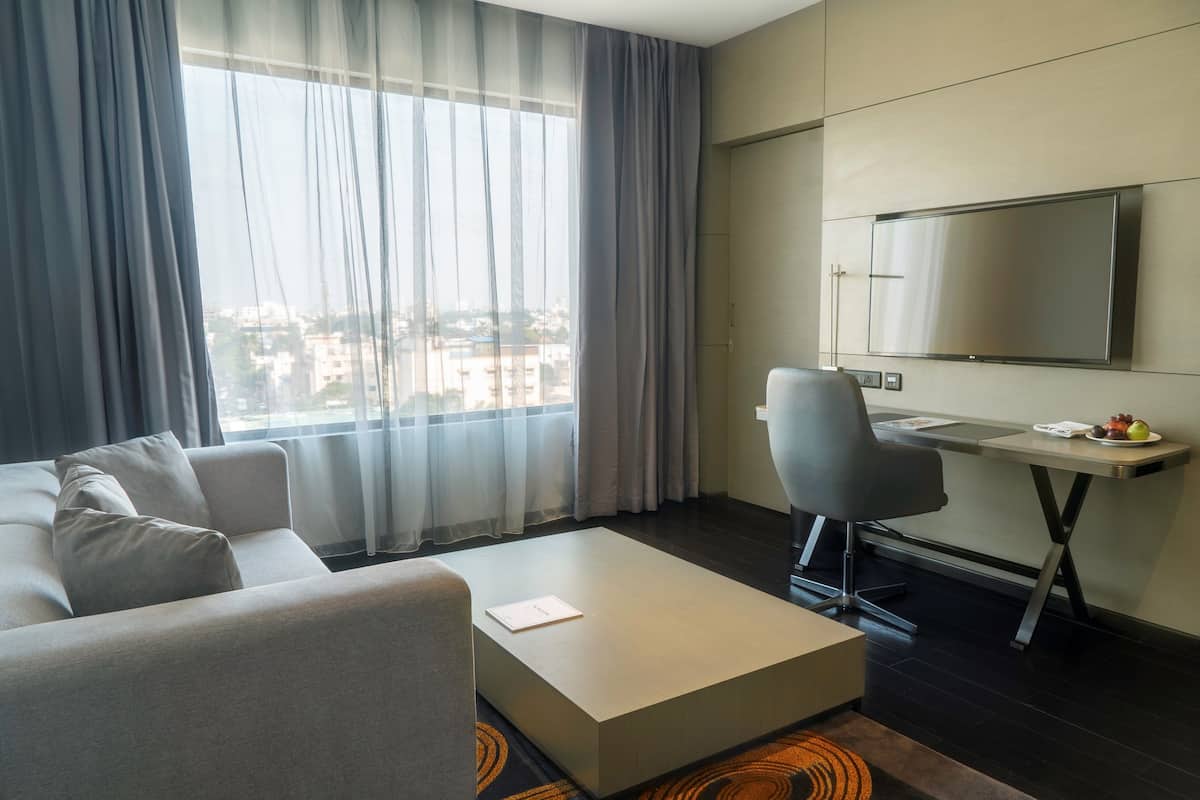 luxury suite, bathtub (separate living room) | living area | tv, ipod dock