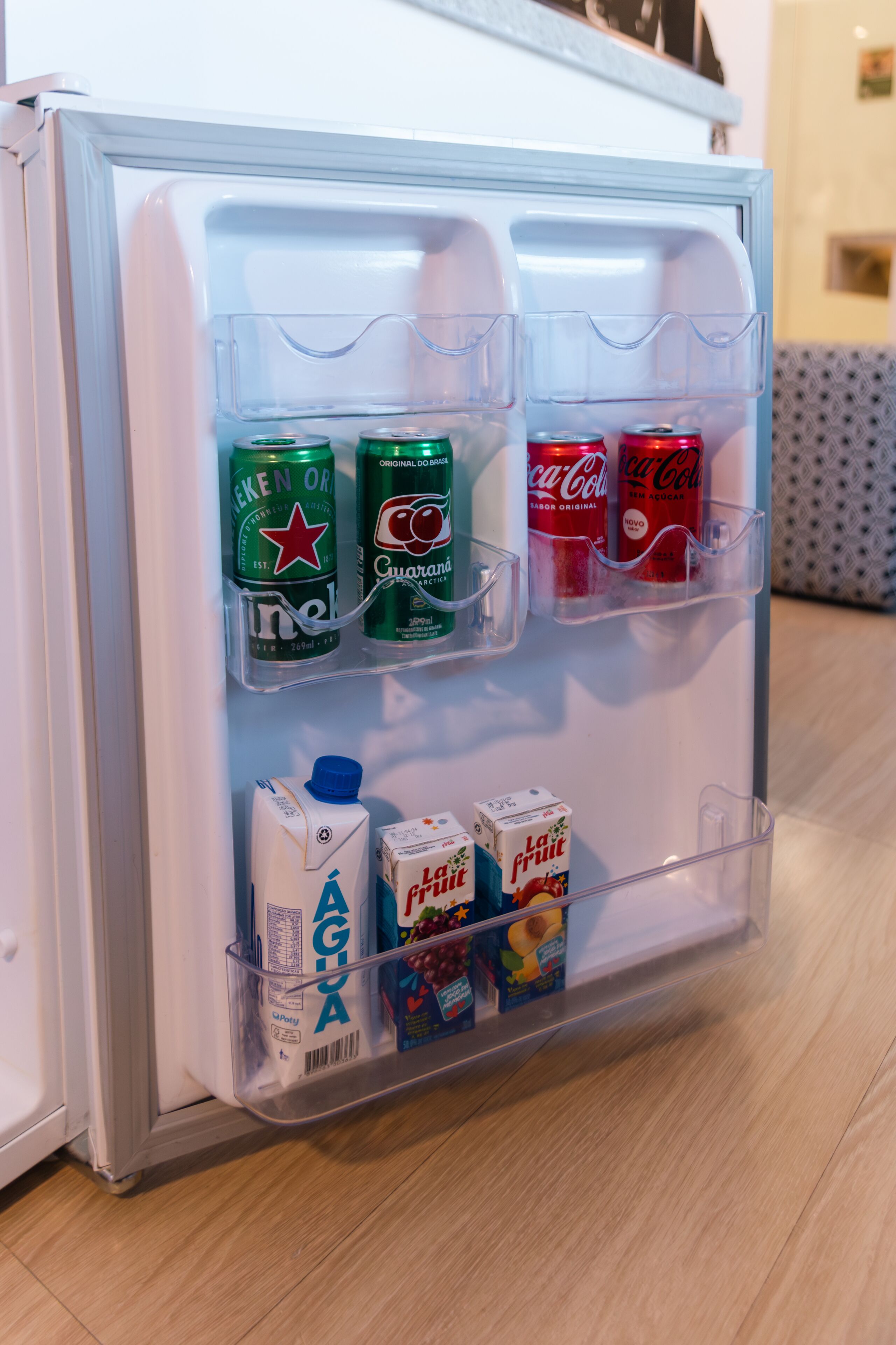 A refrigerator with multiple shelves and compartments, containing various beverages and dairy products.