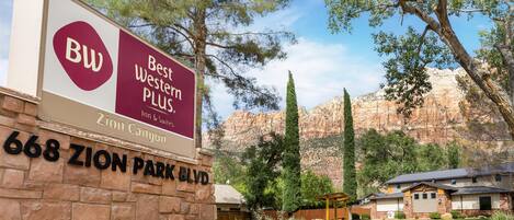 A hotel sign with "Best Western Plus" and "Zion Canyon" written on it, located at 668 Zion Park Blvd.