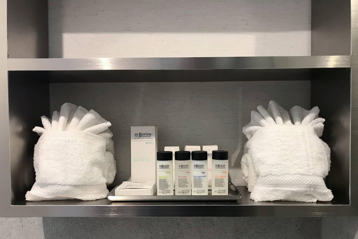 A shelf with a white towel, a box labeled "COBIGELON," and three bottles of "COBIGELON" products.