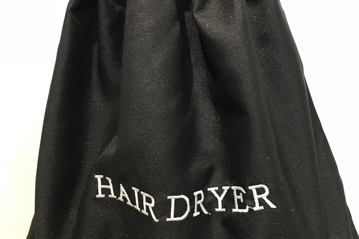 Bañera con ducha, artículos de tocador de diseñador, secador de pelo