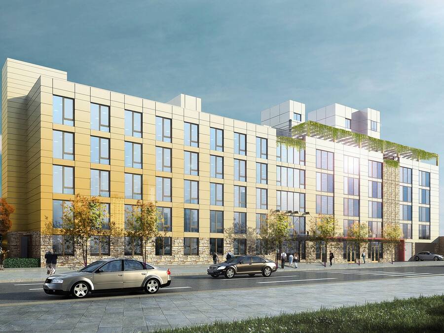A modern multi-story building with a flat facade, large windows, and a rooftop garden.
