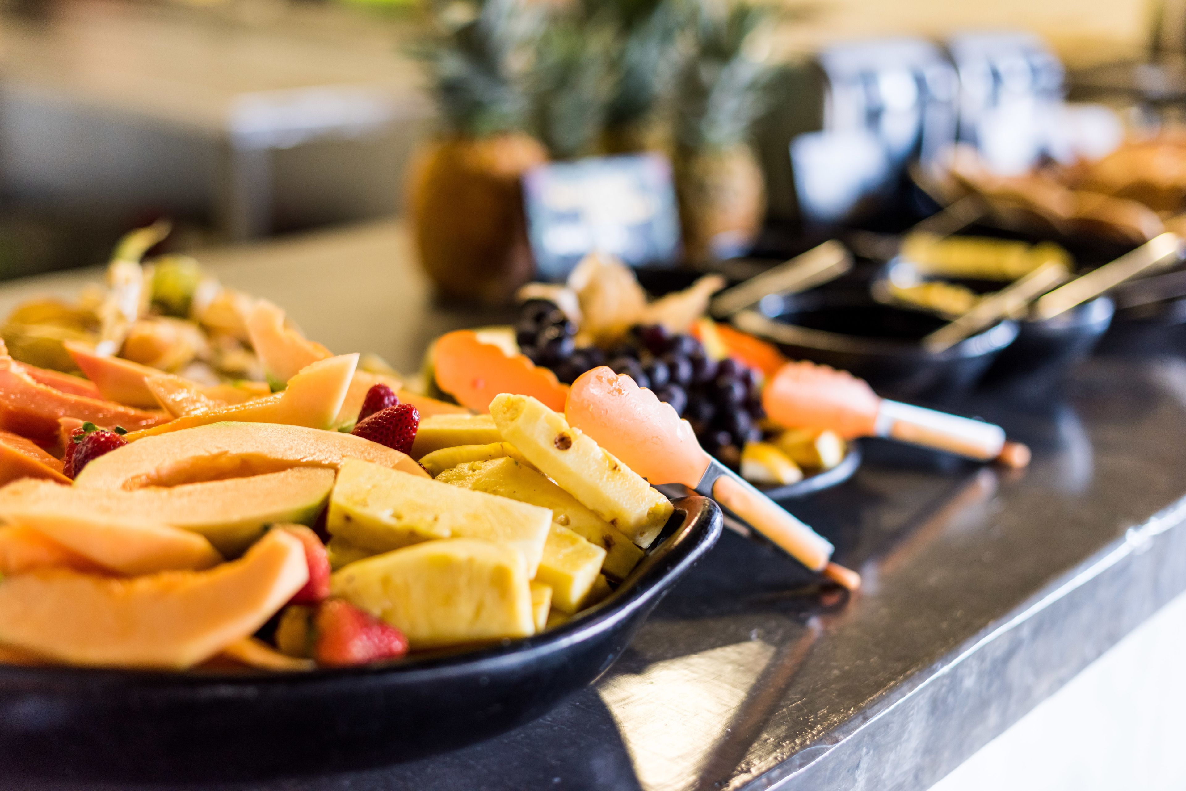 A buffet with various fruits and vegetables.