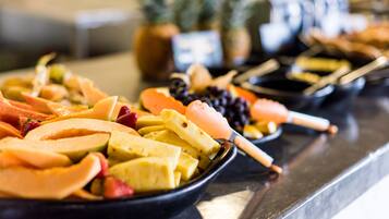 A buffet with various fruits and vegetables.